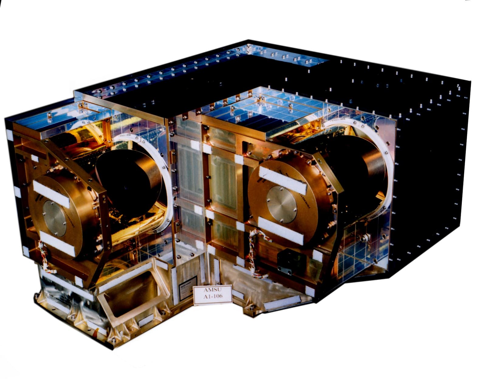 A spherical metal satellite with four long antennas extending from its body, photographed against a plain background.