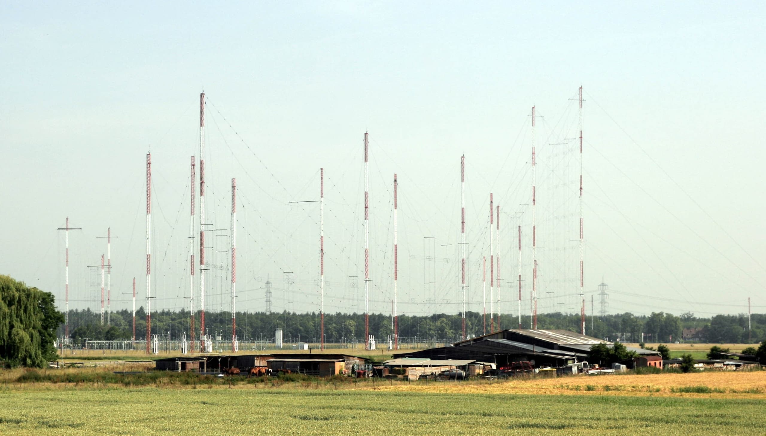 A diagram showing a transmitter connected to an antenna radiating curved lines representing radio waves outward through space toward a receiving antenna connected to a receiver.
