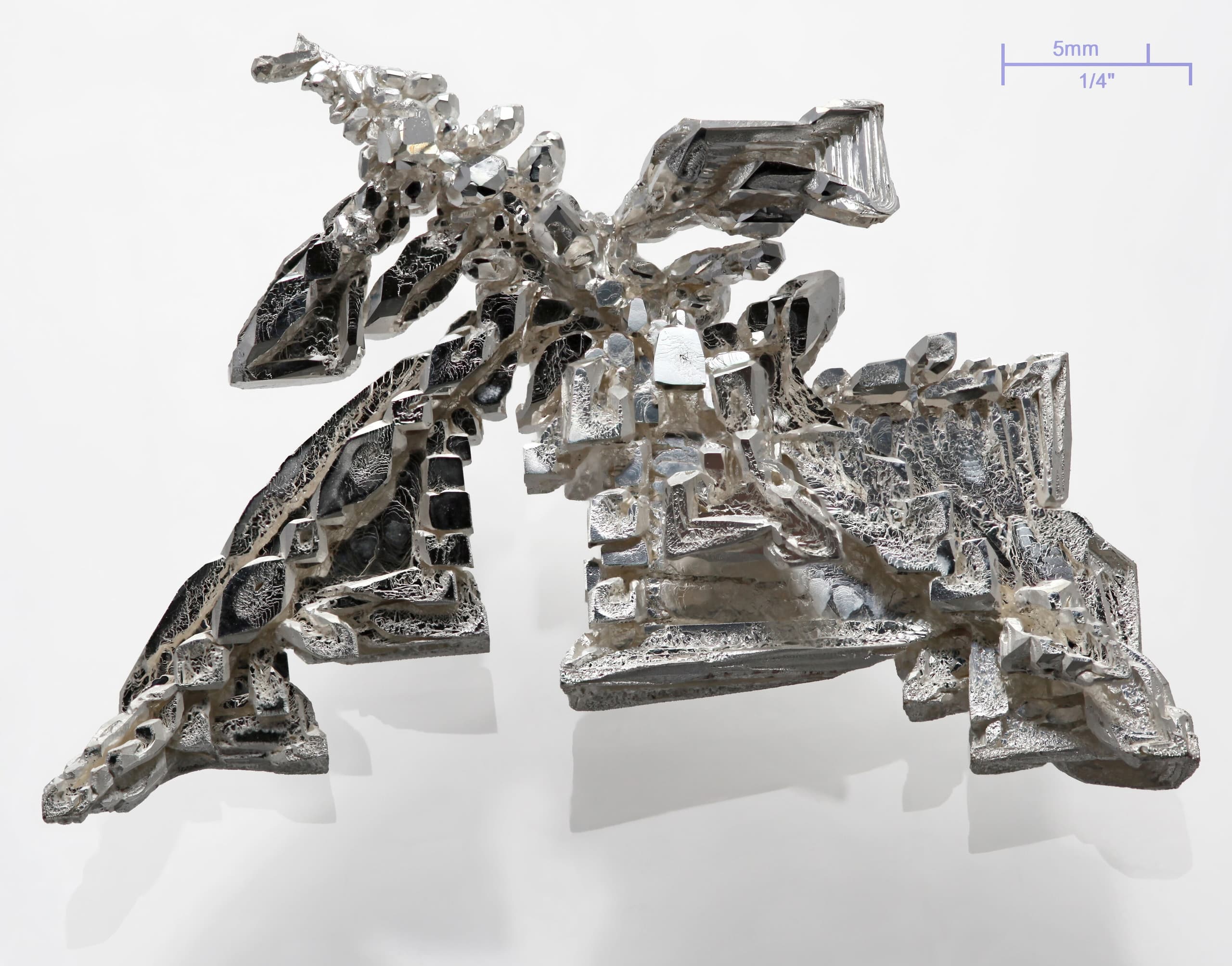 A soft, white, lustrous metal with high reflectivity, shown as a polished sample or in elemental form.