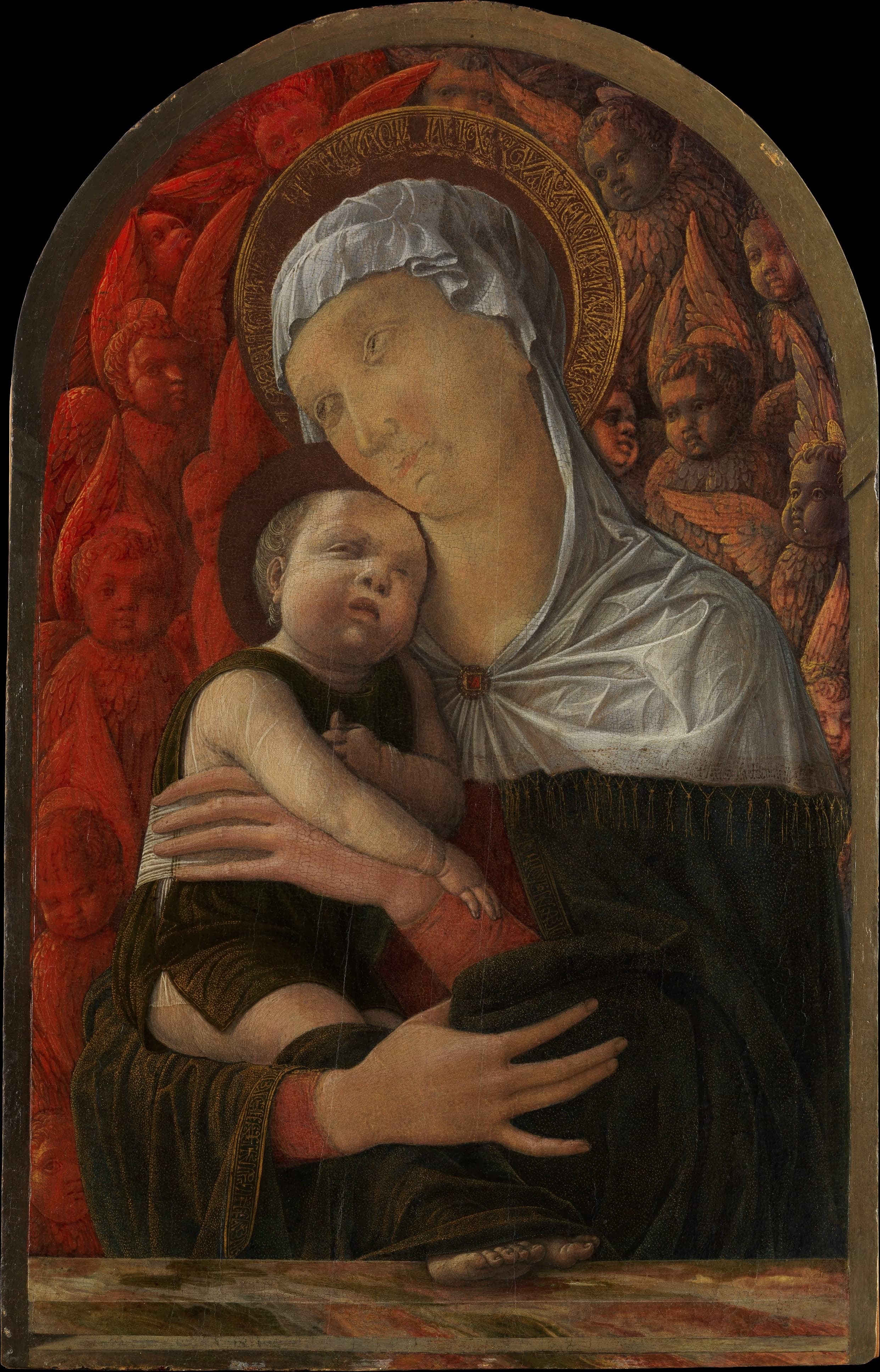 A small vertical panel of the Virgin holding the Child, their faces close, surrounded by a dense ring of angel heads — some cooler blue, some warmer red — above a painted marble ledge.