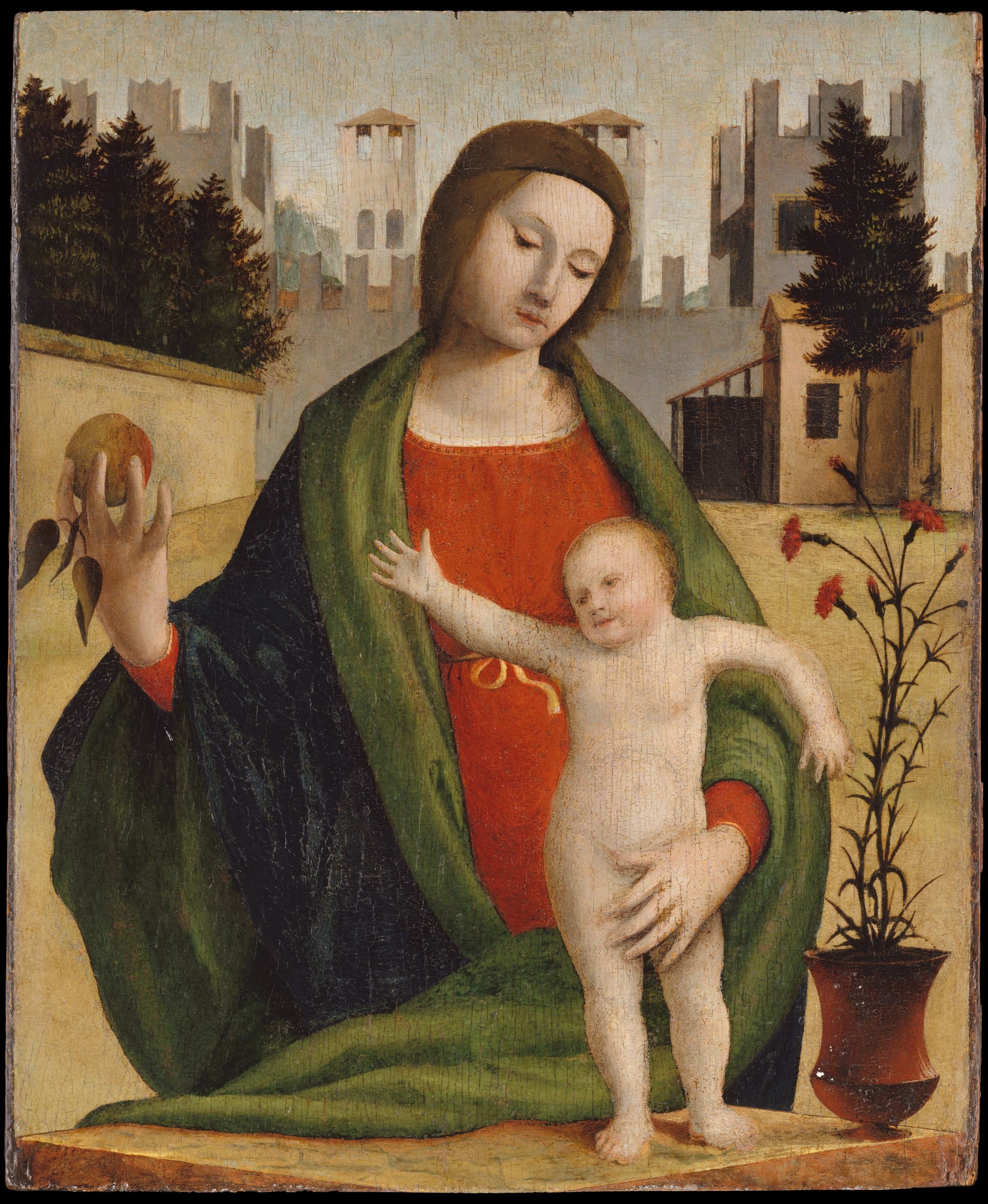 Small tempera panel of the Madonna holding an apple toward a naked Child who stands on a yellow stone cube in a courtyard closed by a crenellated wall with towers; a vase of red flowers nearby.