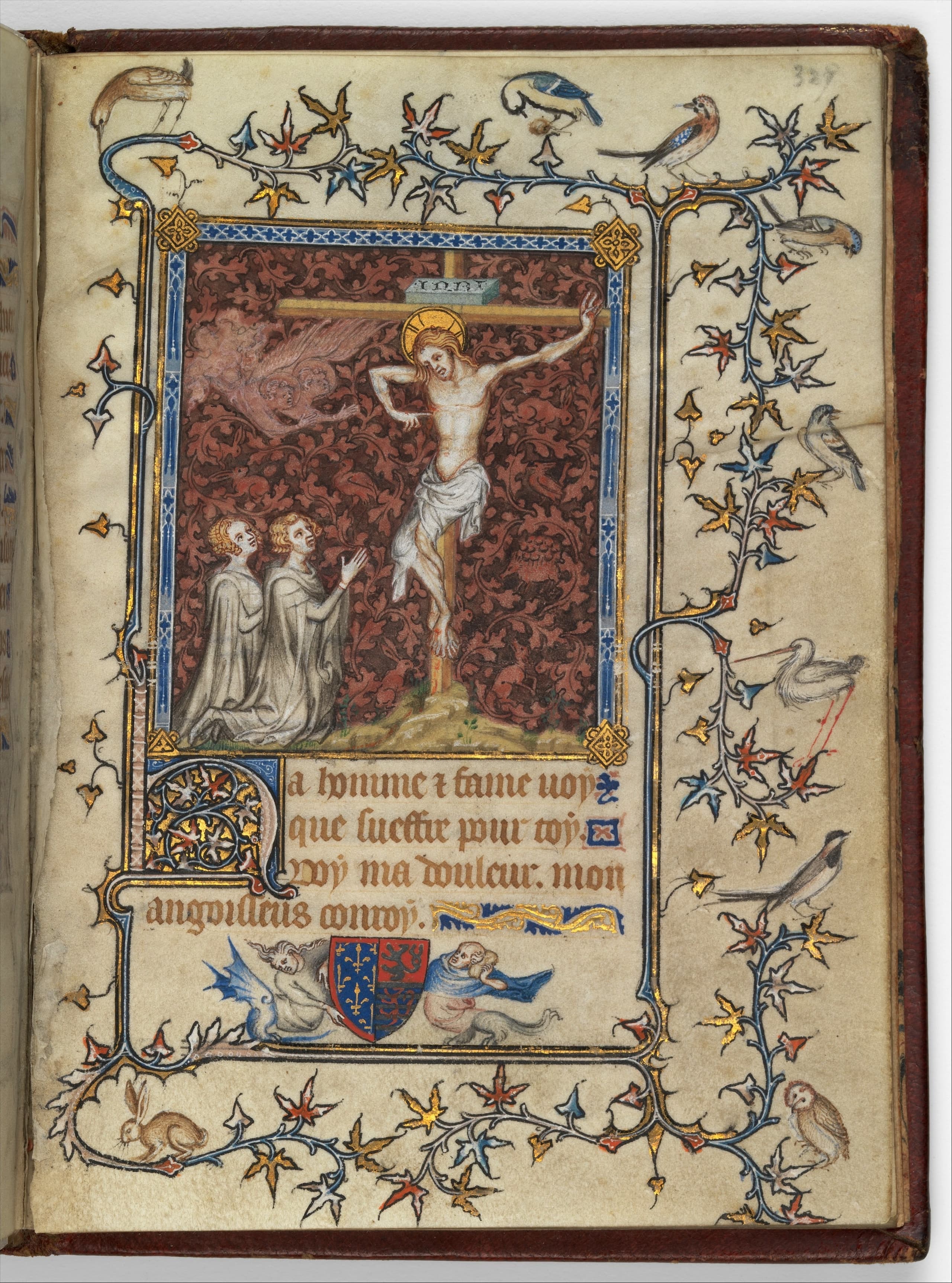A small open manuscript on vellum, pages densely written and painted in tempera and grisaille with passages of gold leaf, sized for holding in the hand.